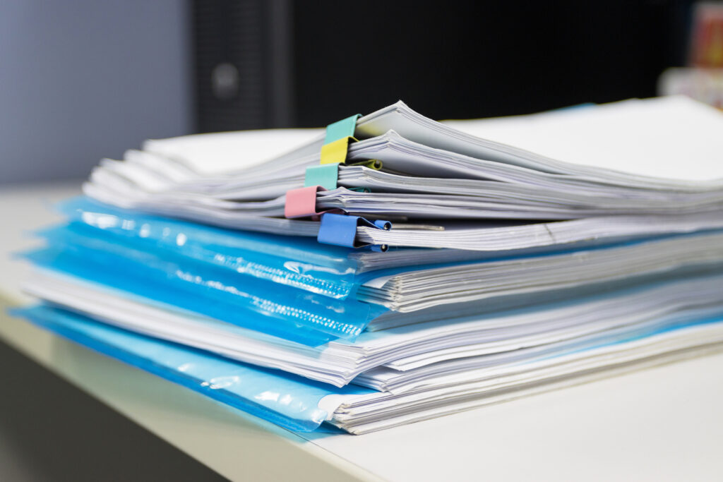 stack of papers with detailed plans and policies